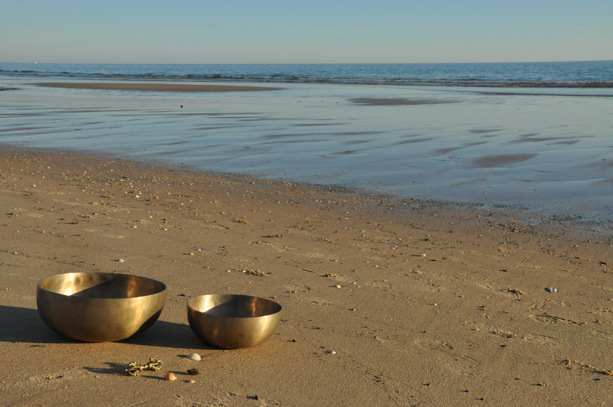 Two singing bowls by the sea